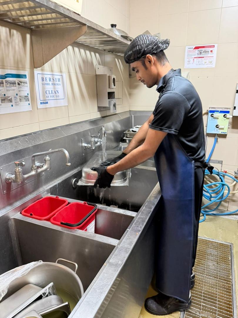 T&M steward sanitising kitchen utensils